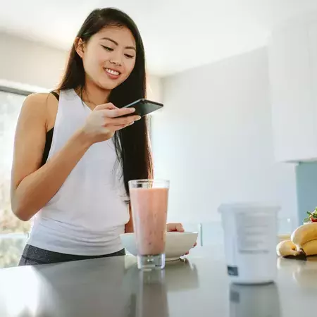 Woman taking a photo of a bowl of cereal