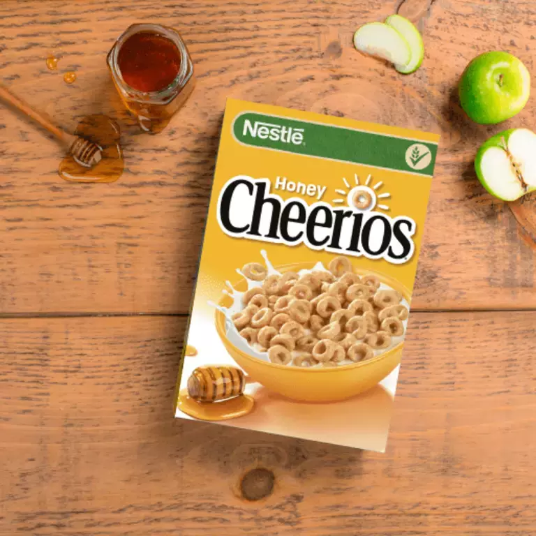 A box of Honey Cheerios Cereal on a table