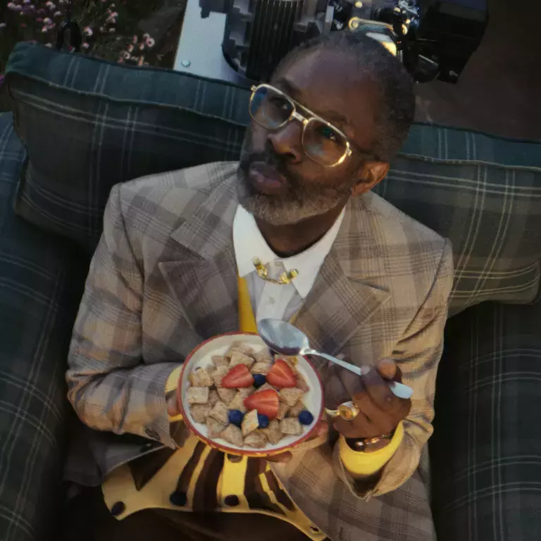 Rudy the inventor is sat on his new flying chair invention eating a bowl of Shredded Wheat bitesize.