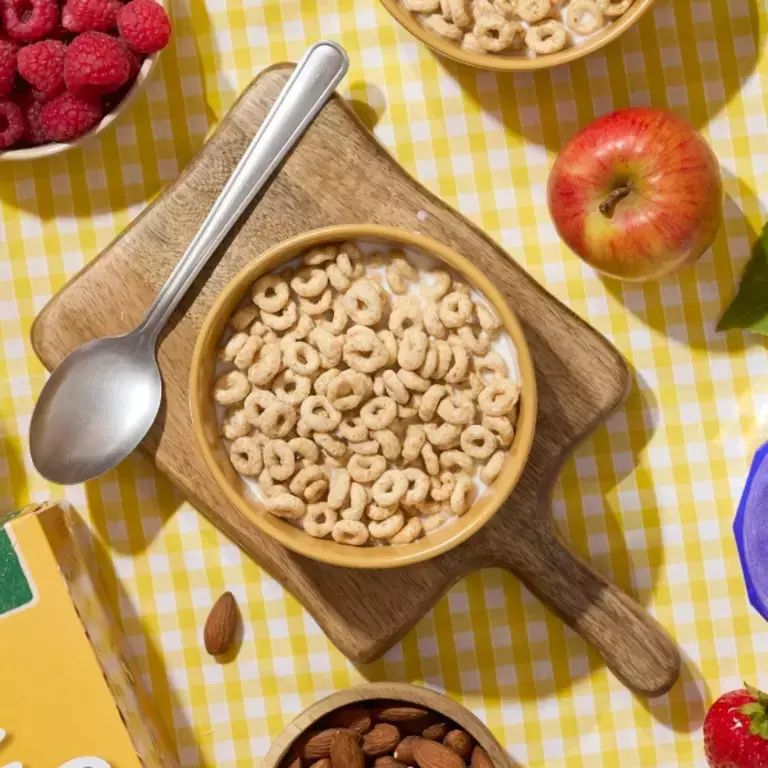 Cheerios with milk, apple, raspberries and almonds